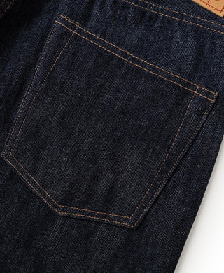 Front patch pocket with orange-stitched outline on dark indigo denim