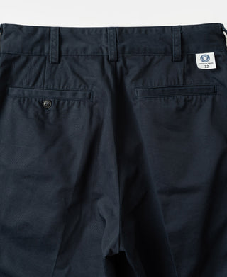 Navy cotton twill trousers with double pleats, zip fly, belt loops, and side pockets.