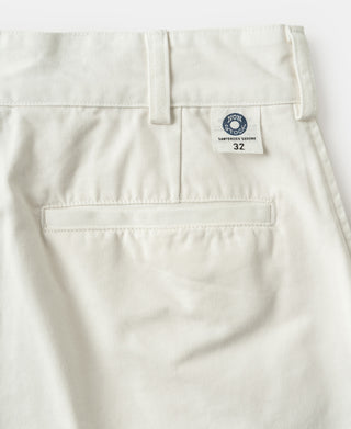 White cotton twill trousers with belt loops, button closure, and size 32 label