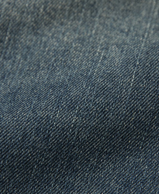 Blue slub denim fabric texture close-up