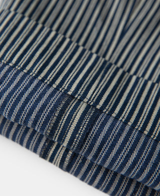 Striped work pants fabric close-up with blue-and-white vertical stripes and cuff
