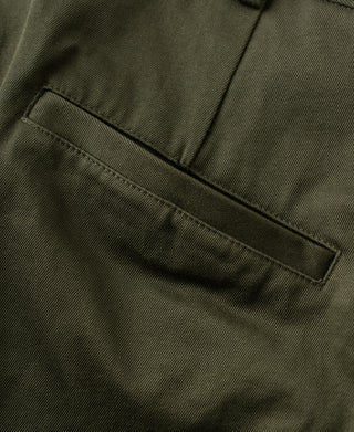 Olive cotton twill trousers with front welt pocket and stitched pleat detail