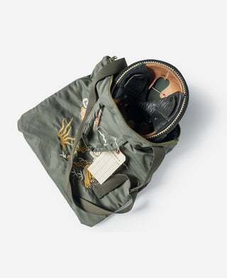 Olive embroidered helmet bag with top zipper opening and adjustable shoulder strap
