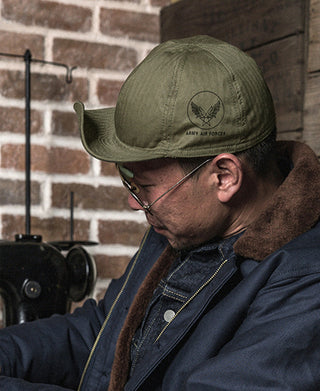 Olive military cap with front emblem, side profile