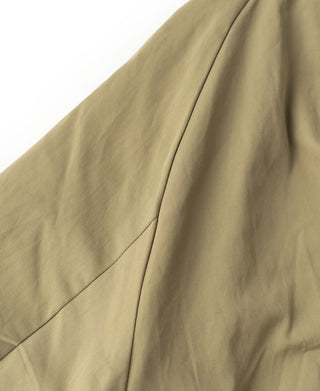 Olive bomber jacket sleeve with curved panel seams and smooth outer fabric