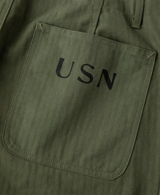 Olive utility pants front pocket with USN patch label
