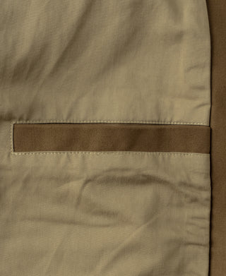 Brown bomber jacket hem with topstitched band and stitched seam