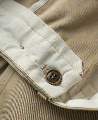 Khaki cotton twill trousers with brown button closure and waistband stitching