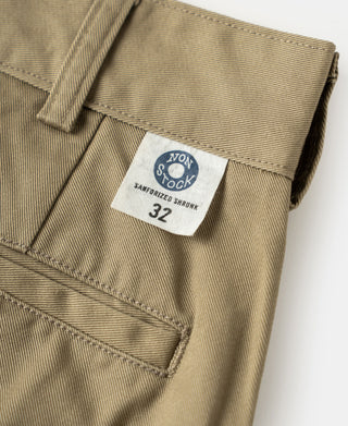 Khaki cotton twill trousers cuff with care label and diagonal stitching