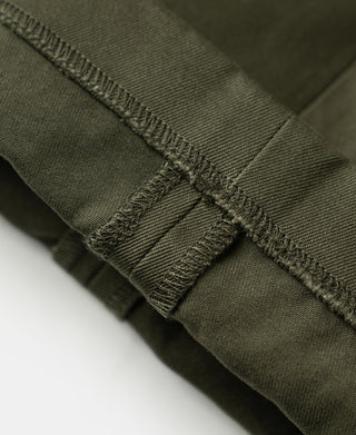 Olive cotton twill trousers with reinforced hem stitching and folded cuff