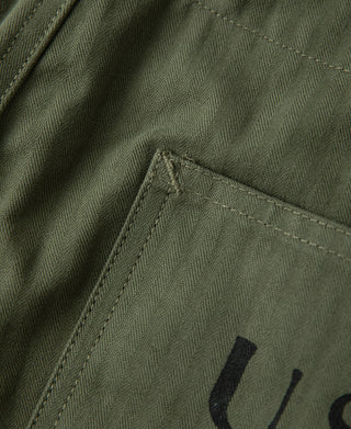 Olive utility pants front pocket with USN lettering detail
