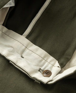 Olive cotton twill trousers showing inside waistband lining and button closure