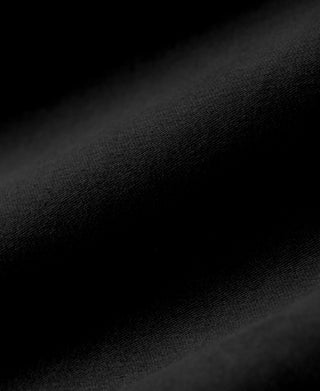 Black moleskin-style fabric close-up with fine textured weave