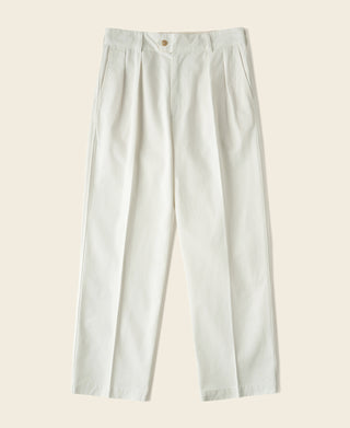White cotton twill trousers with double pleats and front button closure.
