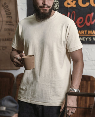 Apricot athletic T-shirt with crew neck, worn by a man holding a tan mug