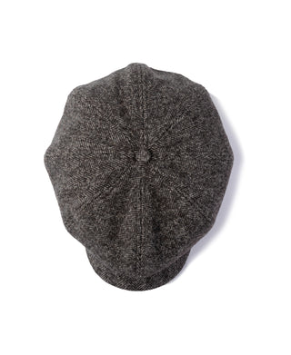 Dark gray herringbone wool newsboy cap with seam detail on the back panel.