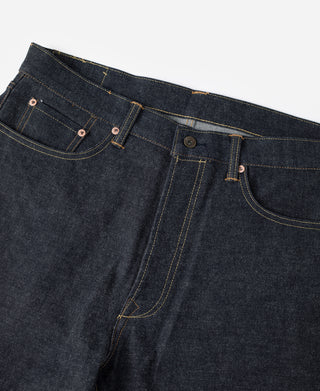 Indigo button-fly denim jeans showing coin pocket, belt loops, and pocket stitching