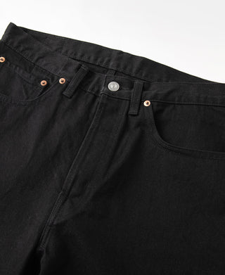 Black denim jeans close-up: waistband with button closure and copper rivets