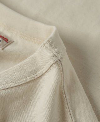 Apricot athletic T-shirt neckline and hem seam detail