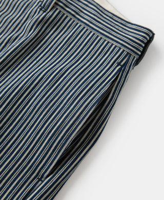 Striped work pants with dark piping at side seam and stitched hem.