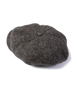 Dark gray herringbone wool newsboy cap with center crown seam and rounded top.