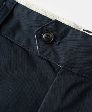 Navy trouser waistband with black button and stitched edge pocket opening