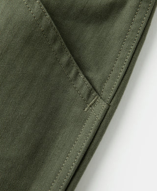 Olive woven fabric pants with stitched side pocket and textured HBT look.
