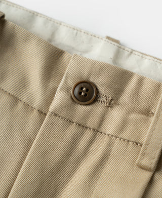 Khaki cotton twill trousers close-up of front pocket flap button