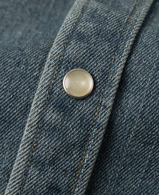Denim shirt snap button with round metal finish on blue slub fabric
