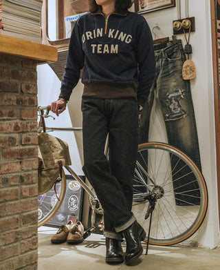 Selvedge denim jeans in dark indigo, back view with belt loops and pocket stitching