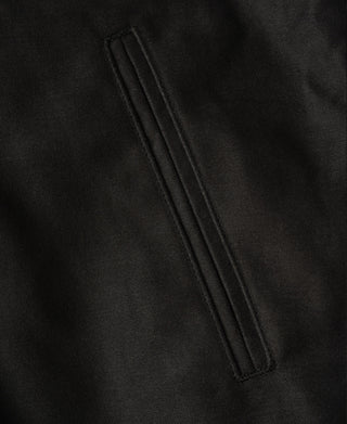 Black bomber jacket side pocket seam with stitched edge detail