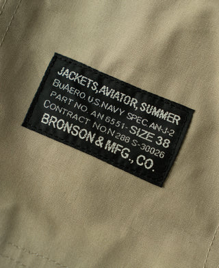 Khaki flight jacket brand label with size and contract details on inner lining