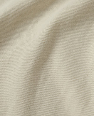Apricot athletic T-shirt fabric, fine knit texture close-up