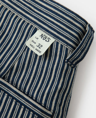 Striped work pants with size label patch and striped waistband corner.