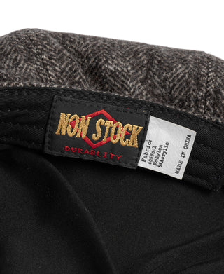 Inside Durability brand tag on dark gray wool newsboy cap lining.