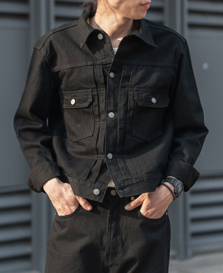 Black denim jacket with two chest flap pockets and snap button front
