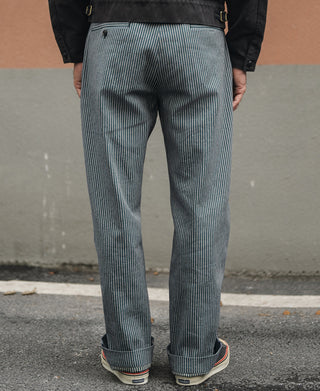 Striped work pants on model, blue-and-white pinstripes with front pleats