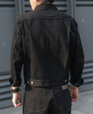 Black denim jacket back view with yoke seam and snap-button waistband