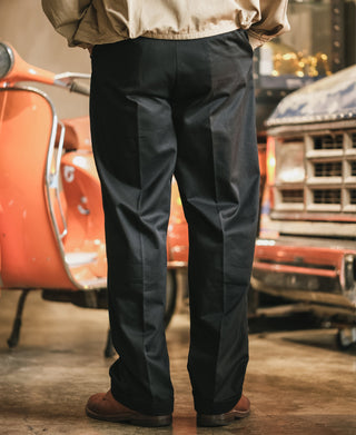 Black cotton twill trousers with straight legs and pressed front creases